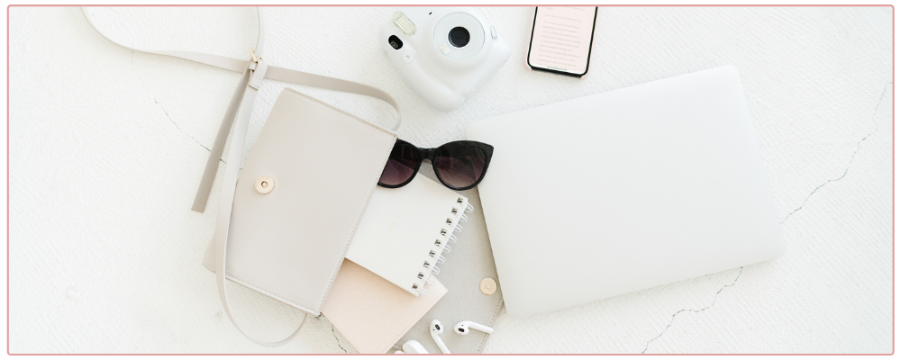 Woman's purse spilled out on desk - for 5 mistakes business owners make when setting goals blog post