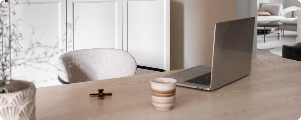 Laptop and coffee on a calm desk setup for writing a blog post and updating your blog page.