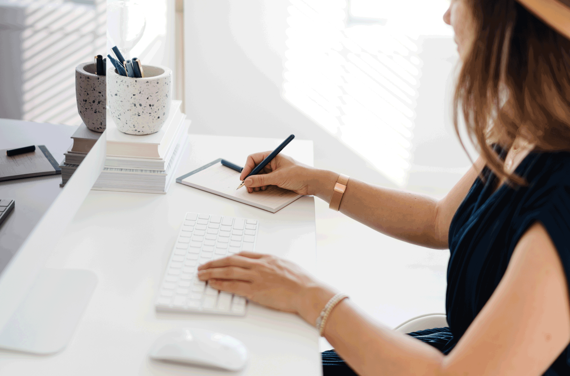 Interovertered Entrepreneur Working on her laptop with a camera beside her.