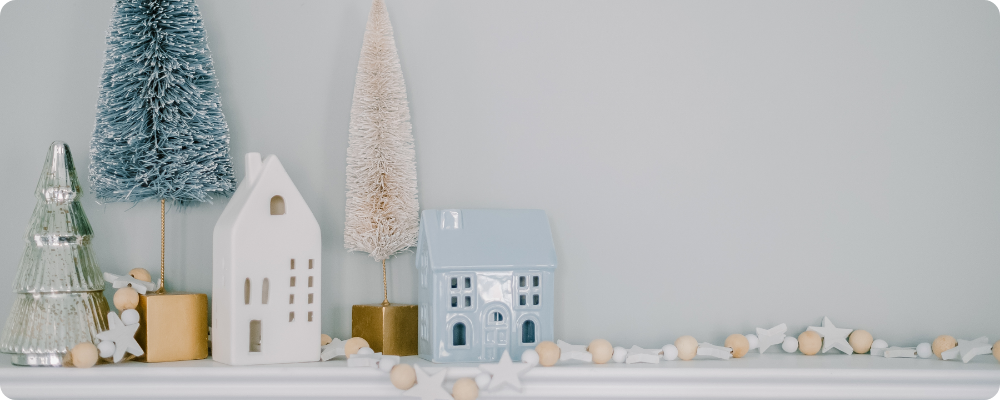 Wide view of cozy Christmas decor on a mantel, creating peaceful space for a blogger to brainstorm new blog post ideas and get back to blogging.