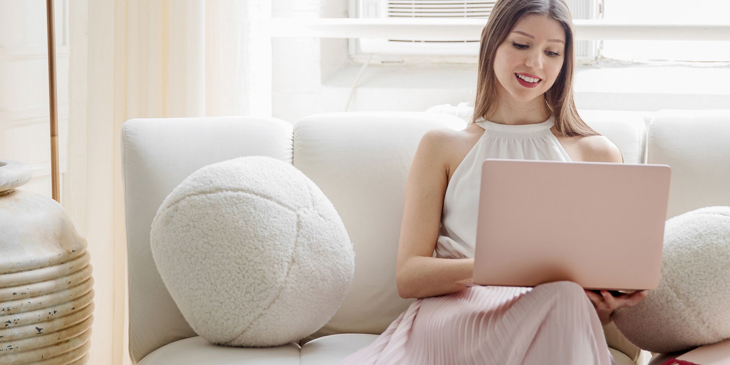 Interovertered Entrepreneur Working on her laptop with a camera beside her.