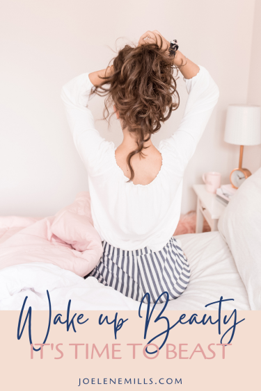 Wake up beaty. It's time to beast. Woman pinning her hair up as she gets out of bed