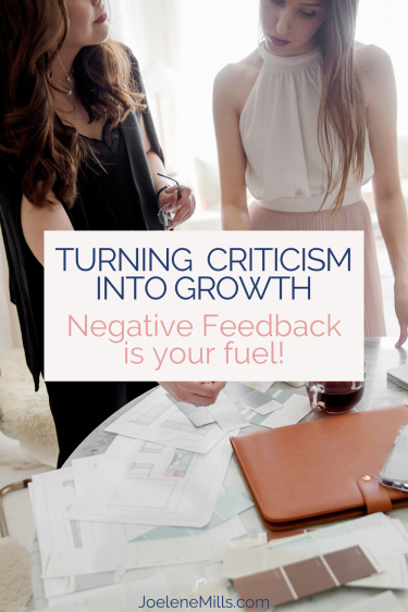 two women working together reviewing items on a table, with the words Turning Criticism into Growth
