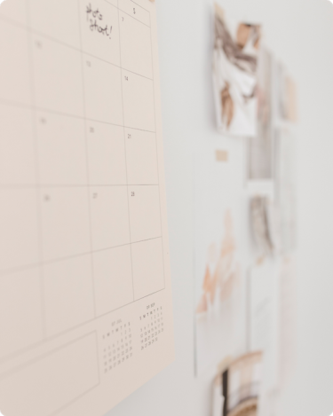 Minimal wall calendar with handwritten note, symbolizing simplified planning and avoiding overstuffed content.