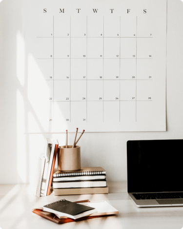 Minimalist home office with wall calendar—visual for blog post on how boundaries help introverted coaches protect your energy.