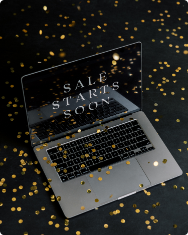 Laptop with “Sale Starts Soon” on screen surrounded by gold confetti, symbolizing noisy Black Friday marketing online.