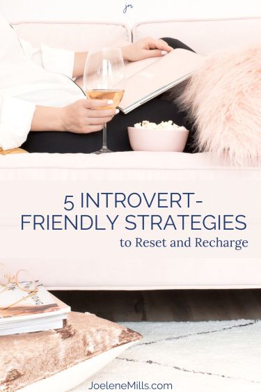 Woman reading a book and drinking wine on the couch with the words 5 introvert-friendly strategies overlayed