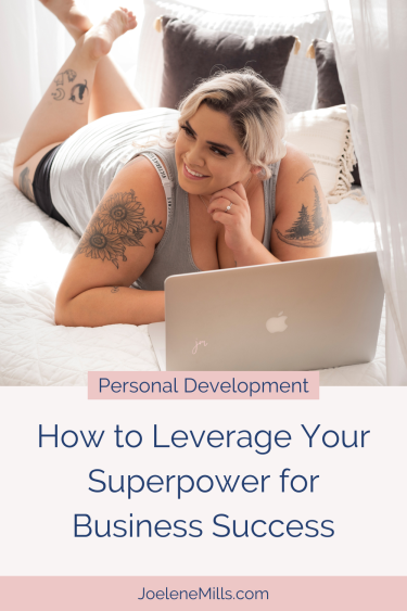 Business woman with tattoos laying on a bed working on her laptop with the words "how to leverage your superpower for business success" below, showing Unique Strengths in Business