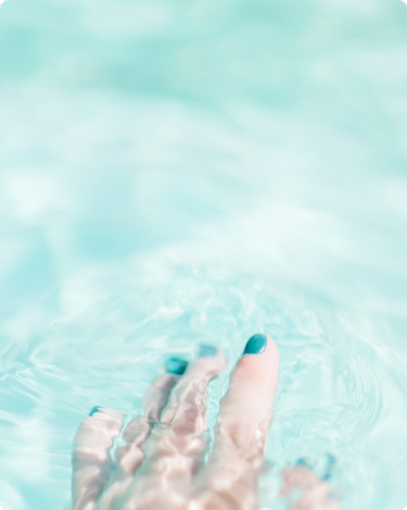 A woman's hand in crystal clear water - emphasizing clarity
