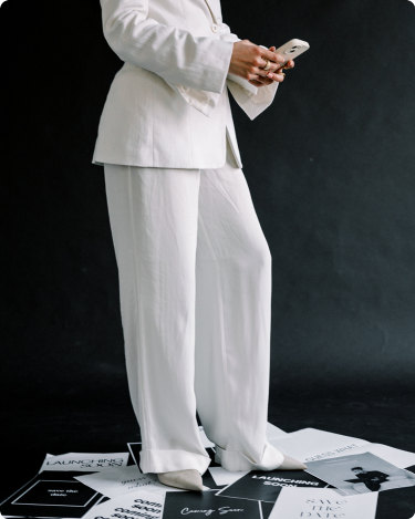 Person standing among “Launching Soon” and “Coming Soon” posters, symbolizing quiet, intentional marketing for Black Friday.