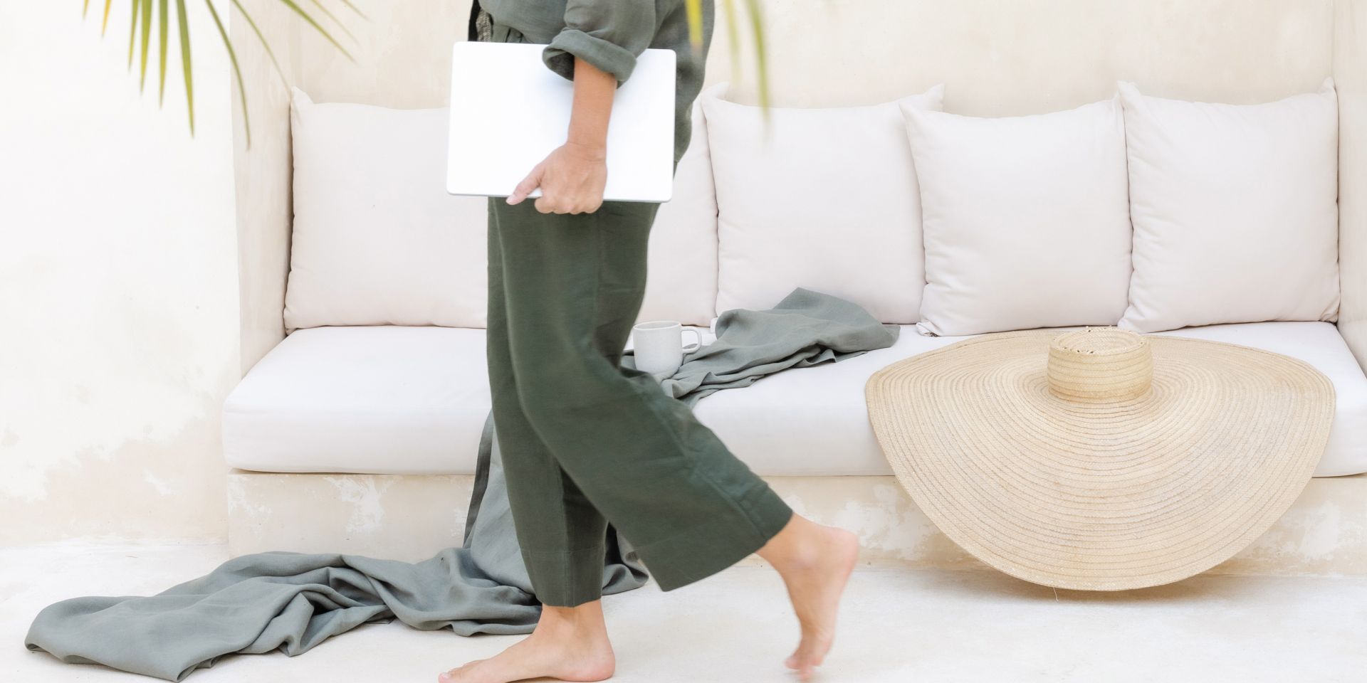 WOman walking with laptop to read the monday motivation newsletter.