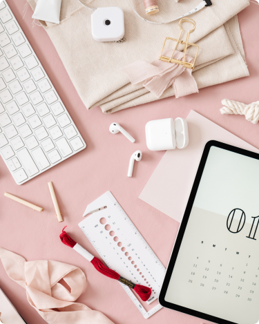 a messy desk with a calendar and lots of clutter - 