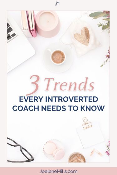 Womans desk with a laptop, coffee and glasses. Pink and gold accessories and the words "2 trends every introverted coach needs to know" 